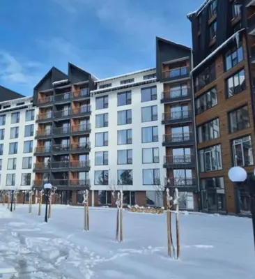 a group of apartment buildings in the snow at Apartman B64 Residence Hill Kopaonik in Kopaonik