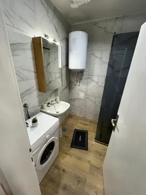 a bathroom with a sink and a washing machine at Apartman Stojanovic in Vranje