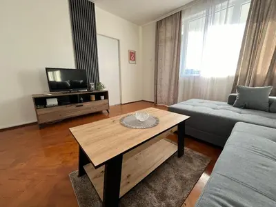 a living room with a couch and a coffee table at Apartman Stojanovic in Vranje