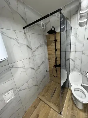 a bathroom with a shower with a toilet at Apartman Stojanovic in Vranje