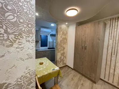 a kitchen with a yellow table in a room at Apartman 911 in Soko Banja