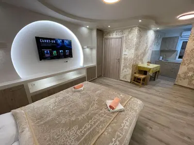 a room with a bed and a tv on a wall at Apartman 911 in Soko Banja