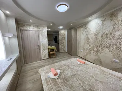 a room with a large bed and a table at Apartman 911 in Soko Banja