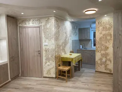 a kitchen with a table and a yellow table and chairs at Apartman 911 in Soko Banja