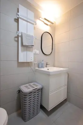 a bathroom with a sink and a mirror and a toilet at Apartman SNEG in Vrnjačka Banja