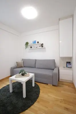 a living room with a couch and a table at Apartman SNEG in Vrnjačka Banja