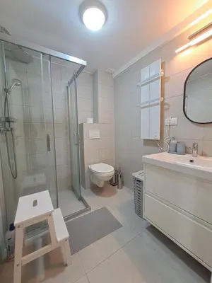 a bathroom with a shower and a toilet and a sink at Apartman SNEG in Vrnjačka Banja