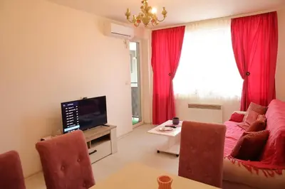 a living room with a couch and a tv at Stan na dan 2 in Paraćin