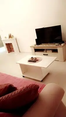 a living room with a tv on a table at Stan na dan 2 in Paraćin