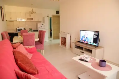 a living room with a red couch and a television at Stan na dan 2 in Paraćin