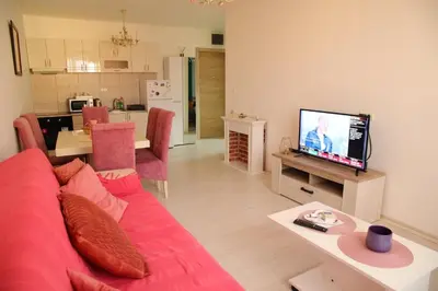 a living room with a red couch and a tv at Stan na dan 2 in Paraćin