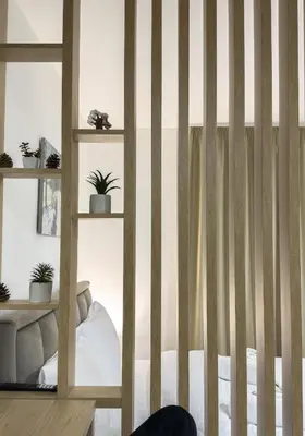 a room with a striped wall with a bed at President Kop A104 in Kopaonik