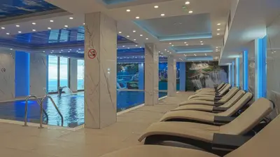 a row of chairs in a room with a pool at President Kop A104 in Kopaonik
