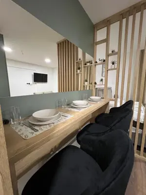a wooden table with chairs and plates on it at President Kop A104 in Kopaonik