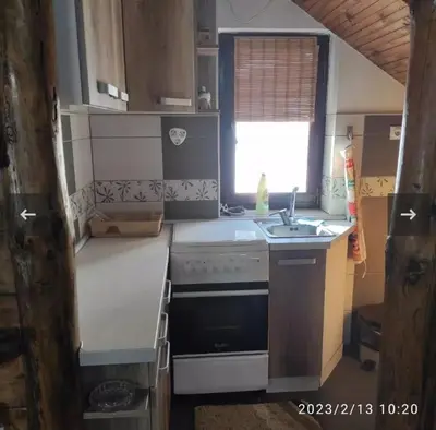 a small kitchen with a sink and a stove at Apartmani Maljković in Knjazevac.