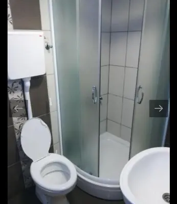 a bathroom with a shower and a toilet and a sink at Apartmani Maljković in Knjazevac.