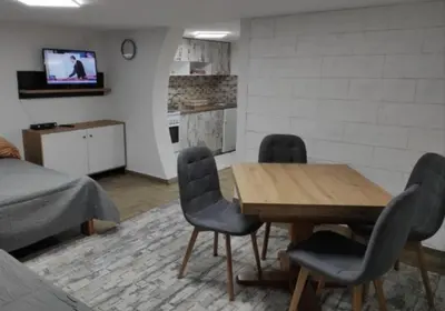 a living room with a wooden table and chairs at Apartmani Maljković in Knjazevac.