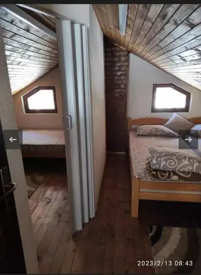 a bedroom with two beds and two windows at Apartmani Maljković in Knjazevac.