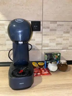 a black coffee maker sitting on a counter at Apartman Filip in Kruševac