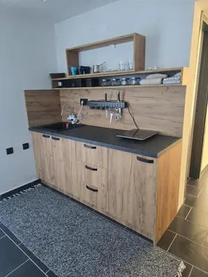 a bathroom counter with a sink and a mirror at Tara Apartments Kopaonik in Kopaonik
