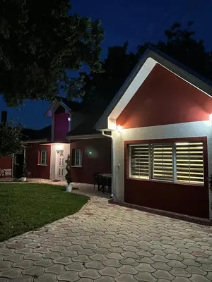 a house with two garage doors at night at Studio Ivana 3 in Soko Banja