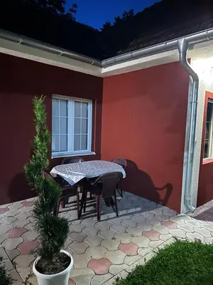 a patio with a table and chairs in a house at Studio Ivana 3 in Soko Banja