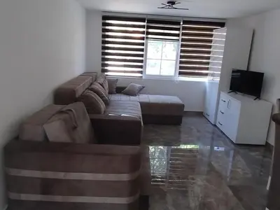 a living room with a couch and a television at Studio Ivana 3 in Soko Banja