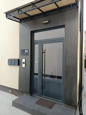 an entrance to a building with a glass door at Gold Apartman in Kruševac