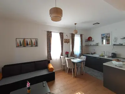a living room with a couch and a table at Gold Apartman in Kruševac