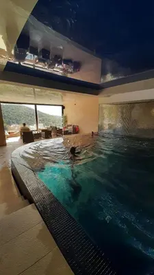 a person swimming in a large swimming pool at Apartman Milovan in Kopaonik