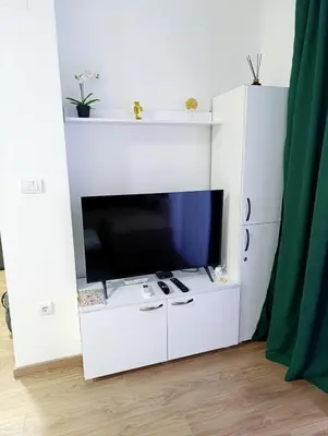 a white entertainment center with a flat screen tv at MSapartman in Vrnjačka Banja