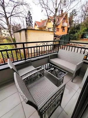 two chairs and a bench on a balcony at MSapartman in Vrnjačka Banja