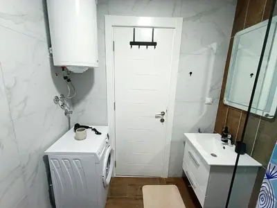 a bathroom with a white door and a sink at MSapartman in Vrnjačka Banja
