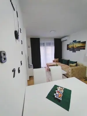 a living room with a white table and chairs at MSapartman in Vrnjačka Banja