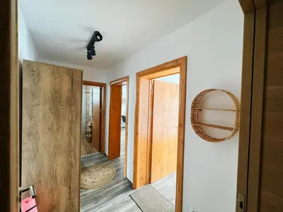 a bathroom with a wooden door and a mirror at Ski2Door Apartment - Sunčani Breg, 50m from Ski Slope in Kopaonik