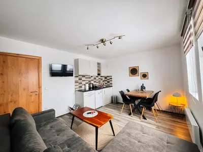 a living room with a couch and a table at Ski2Door Apartment - Sunčani Breg, 50m from Ski Slope in Kopaonik