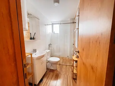 a bathroom with a white toilet and a sink at Ski2Door Apartment - Sunčani Breg, 50m from Ski Slope in Kopaonik
