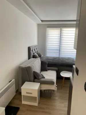 a living room with a couch and a window at Residence Hill , apartman Stefan A023 in Kopaonik