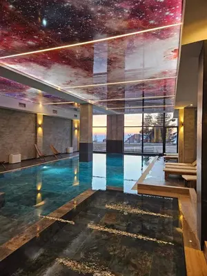 a swimming pool in a building with a star ceiling at Residence Hill , apartman Stefan A023 in Kopaonik