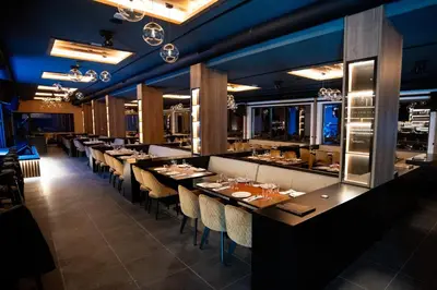 a dining room with long tables and chairs at Apart-Hotel Ariš Kopaonik in Kopaonik