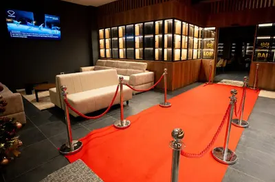 a red carpet in a room with a couch and a table at Apart-Hotel Ariš Kopaonik in Kopaonik