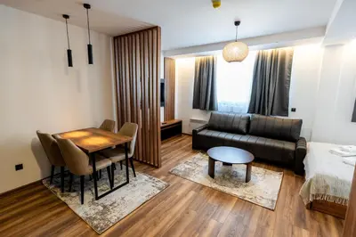 a living room with a couch and a table at Apart-Hotel Ariš Kopaonik in Kopaonik