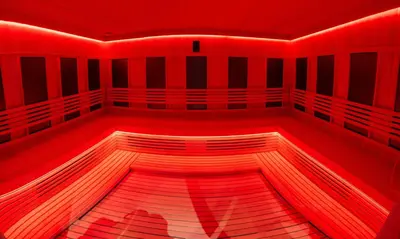 a red room with a wooden floor and red lights at Apart-Hotel Ariš Kopaonik in Kopaonik