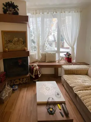 a living room with a couch and a fireplace at Kopaonik Apartman Nina in Kopaonik