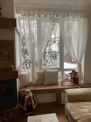 a living room with a couch and a window at Kopaonik Apartman Nina in Kopaonik