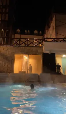a person in a swimming pool at night at Kopaonik Apartman Nina in Kopaonik