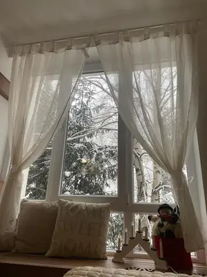 a window with white curtains in a room at Kopaonik Apartman Nina in Kopaonik