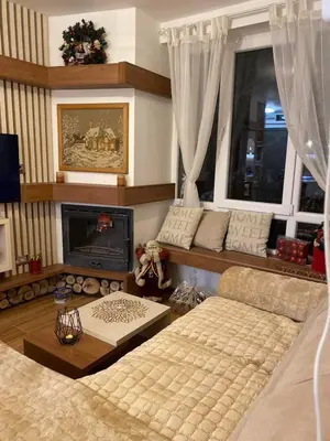 a living room with a couch and a fireplace at Kopaonik Apartman Nina in Kopaonik