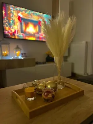 a tray with gold balls and a vase on a table at Apartman S in Vrnjci