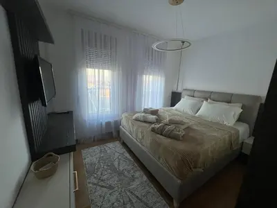 a bedroom with a bed and a television in it at Apartman S in Vrnjci